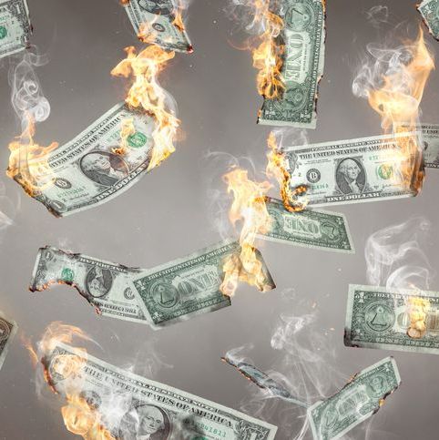 falling dollar bills that are on fire