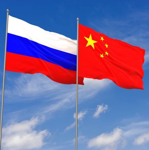 Russian flag & Chinese flag blowing in the wind