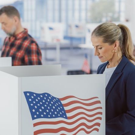 a man and woman voting in separate booths